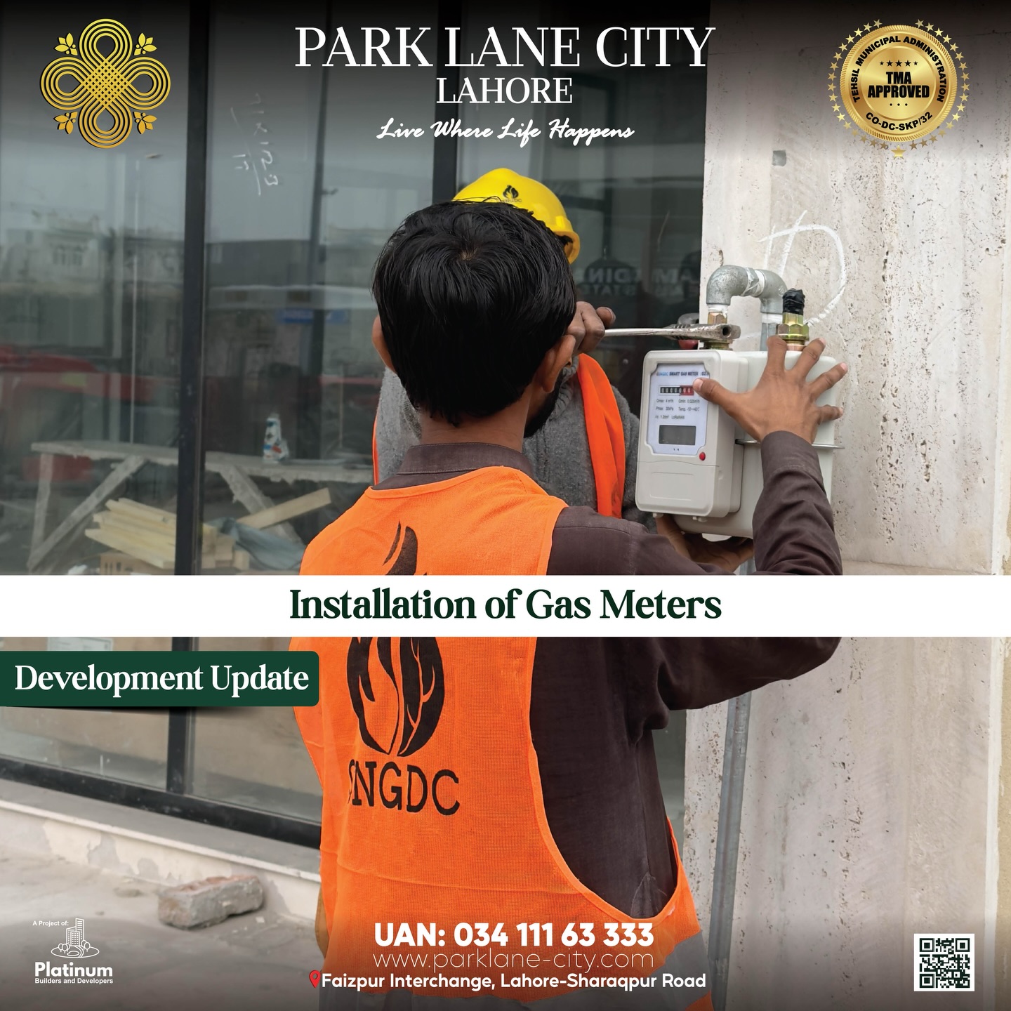 SNGDC technician in orange vest installing gas meter on wall of newly built home