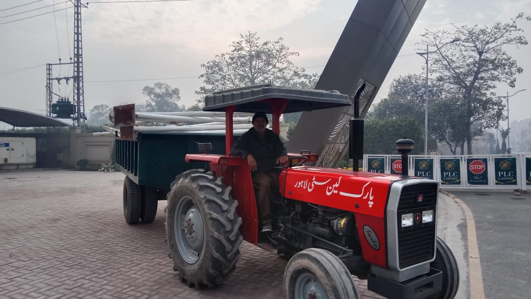 PLC branded tractor at main gate — day-to-day operations